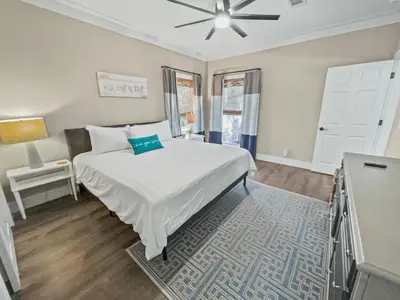 a white bedroom with a bed and a table at Pinewood l Inlet Beach l Dog Friendly in Inlet Beach
