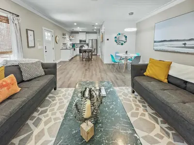 a living room with two couches and a table at Pinewood l Inlet Beach l Dog Friendly in Inlet Beach