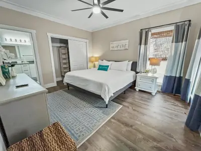 a bedroom with a white bed and a desk and window at Pinewood l Inlet Beach l Dog Friendly in Inlet Beach
