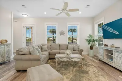 a living room with a couch and a table at Pura Vida l 5 Bedroom l Private Pool l Walk to Beach l Panama City Beach in Panama City Beach