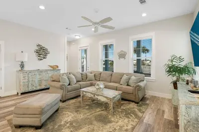 a living room with a couch and a table at Pura Vida l 5 Bedroom l Private Pool l Walk to Beach l Panama City Beach in Panama City Beach