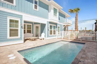 a swimming pool in front of a house at Pura Vida l 5 Bedroom l Private Pool l Walk to Beach l Panama City Beach in Panama City Beach