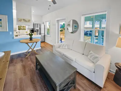 a living room with a white couch and a table at Sand Piper l 4 Minute Walk to the Beach l Inlet Beach in Inlet Beach