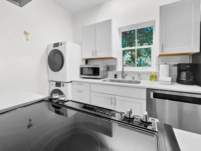 a white kitchen with a sink and a microwave at Sand Piper l 4 Minute Walk to the Beach l Inlet Beach in Inlet Beach