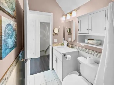 a white bathroom with a toilet and a sink at Sand Piper l 4 Minute Walk to the Beach l Inlet Beach in Inlet Beach