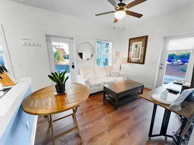 a living room with a white couch and a table at Sand Piper l 4 Minute Walk to the Beach l Inlet Beach in Inlet Beach