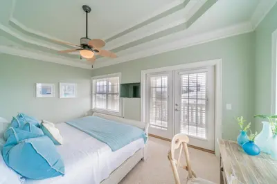 a bedroom with a bed and a ceiling fan at Sand Seair l Private Heated Pool l Bikes and Golf Cart included in Inlet Beach