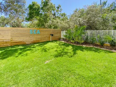 a yard with a fence with the word sa written on it at Sand Seair l Private Heated Pool l Bikes and Golf Cart included in Inlet Beach