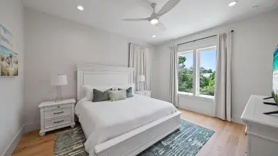 a white bedroom with a bed and a window at Sand Wand l 5 Beds l 5 and half Bath l Private Pool l Walk to Beach l Seagrove Beach 30A in Santa Rosa Beach