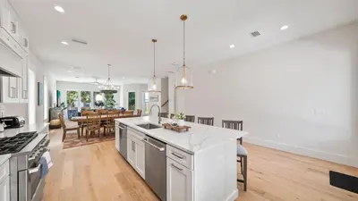 a kitchen with white appliances and a dining room at Sand Wand l 5 Beds l 5 and half Bath l Private Pool l Walk to Beach l Seagrove Beach 30A in Santa Rosa Beach