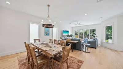 a dining room and living room with a table and chairs at Sand Wand l 5 Beds l 5 and half Bath l Private Pool l Walk to Beach l Seagrove Beach 30A in Santa Rosa Beach