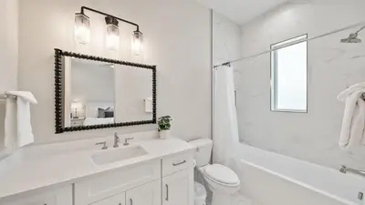 a white bathroom with a sink and a mirror at Sand Wand l 5 Beds l 5 and half Bath l Private Pool l Walk to Beach l Seagrove Beach 30A in Santa Rosa Beach