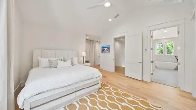 a white bedroom with a bed and a bath tub at Sand Wand l 5 Beds l 5 and half Bath l Private Pool l Walk to Beach l Seagrove Beach 30A in Santa Rosa Beach