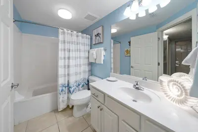 a bathroom with a sink and a toilet and a shower at Sea Horsey Retreat l Community Heated Pool l Amazing Ocean Views l Beachfront Condo in Panama City Beach