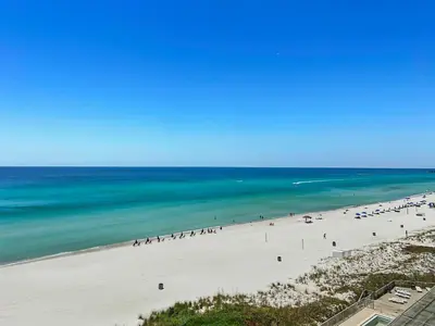 a view of a beach with people on it at Sea Horsey Retreat l Community Heated Pool l Amazing Ocean Views l Beachfront Condo in Panama City Beach