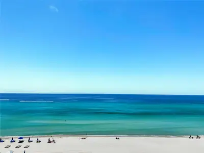 a view of a beach with chairs and the ocean at Sea Horsey Retreat l Community Heated Pool l Amazing Ocean Views l Beachfront Condo in Panama City Beach