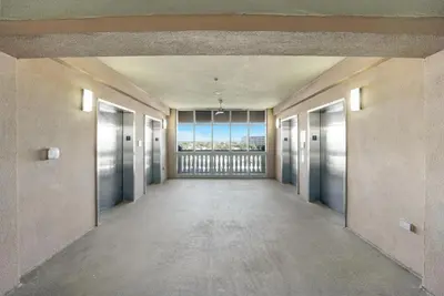 an empty hallway in a building with a large window at Sea Horsey Retreat l Community Heated Pool l Amazing Ocean Views l Beachfront Condo in Panama City Beach
