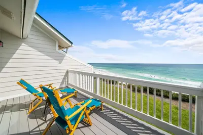 two chairs on a balcony with the beach at Seacrest 6 l Beachfront l Bike to Alys and Rosemary Beach in Seacrest