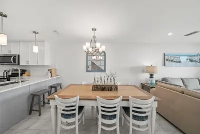 a kitchen and dining room with a wooden table and chairs at Seacrest 6 l Beachfront l Bike to Alys and Rosemary Beach in Seacrest