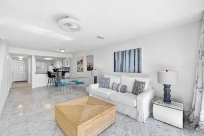 a living room with a white couch and a table at Seacrest 8 l Beachfront l Bike to Alys and Rosemary Beach in Seacrest