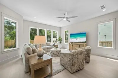 a living room with a couch and chairs and windows at Shore Thing l Private Pool l Walk to the beach l Bike to Seaside l Brand New Construction and Decor in Santa Rosa Beach
