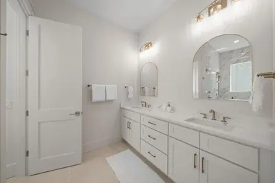 a white bathroom with a sink and a mirror at Shore Thing l Private Pool l Walk to the beach l Bike to Seaside l Brand New Construction and Decor in Santa Rosa Beach