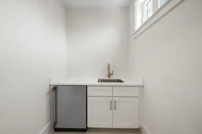 a white kitchen with a sink and a window at Shore Thing l Private Pool l Walk to the beach l Bike to Seaside l Brand New Construction and Decor in Santa Rosa Beach