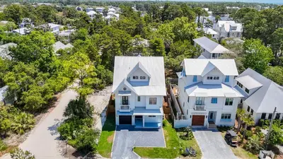 an aerial view of a blue and white house at Shore Thing l Private Pool l Walk to the beach l Bike to Seaside l Brand New Construction and Decor in Santa Rosa Beach
