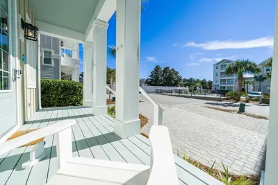 a white porch with a bench on a house at Someday Came l 4 Bikes and Beach Towels l Community Pool in Inlet Beach