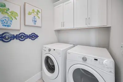 a white laundry room with a washer and dryer at Someday Came l 4 Bikes and Beach Towels l Community Pool in Inlet Beach