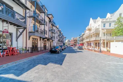 a city street with parked cars and buildings at Someday Came l 4 Bikes and Beach Towels l Community Pool in Inlet Beach