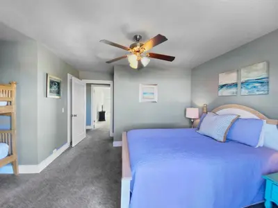 a bedroom with a blue bed and a ceiling fan at Shoreline Townhomes 10 l Steps to the Beach l Beautiful views from 2nd and 3rd balconies in Inlet Beach