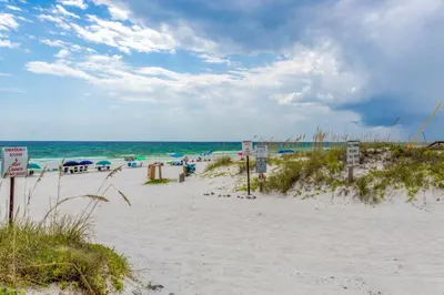 a sandy beach with a view of the ocean at Shoreline Townhomes 10 l Steps to the Beach l Beautiful views from 2nd and 3rd balconies in Inlet Beach