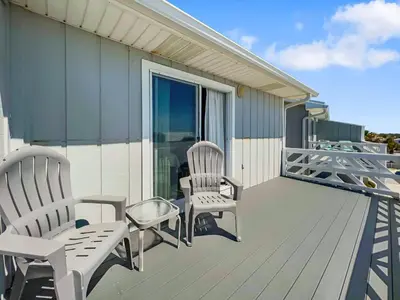 a deck with two chairs and a bench on it at Shoreline Townhomes 10 l Steps to the Beach l Beautiful views from 2nd and 3rd balconies in Inlet Beach