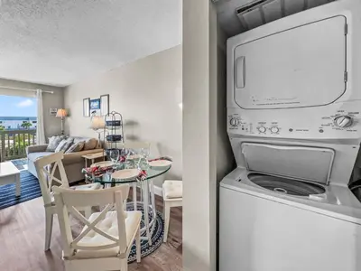 a kitchen and living room with a table and a laundry machine at SummerSalt l Ocean Views l Heated Community Pool l Dog Friendly in Seagrove Beach