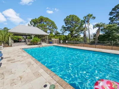 a swimming pool with a gazebo at SummerSalt l Ocean Views l Heated Community Pool l Dog Friendly in Seagrove Beach