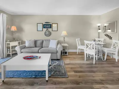 a living room with a couch and a table at SummerSalt l Ocean Views l Heated Community Pool l Dog Friendly in Seagrove Beach
