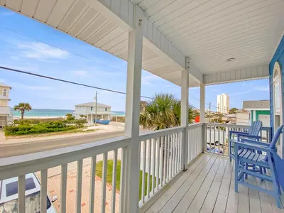 a porch with a blue bench and the ocean at SummerTowne 1 At Pier Park l Amazing Ocean Views l Dog Friendly l Community Pool in Panama City Beach