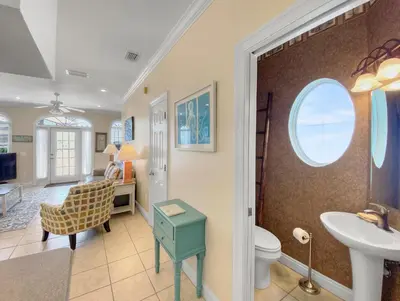a bathroom with a sink and a toilet and a desk at SummerTowne 1 At Pier Park l Amazing Ocean Views l Dog Friendly l Community Pool in Panama City Beach