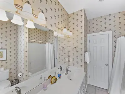 a bathroom with a tub and a sink at SummerTowne 1 At Pier Park l Amazing Ocean Views l Dog Friendly l Community Pool in Panama City Beach