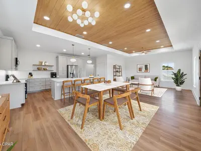 a kitchen and dining room with a table and chairs at PCB Luxe 4BR, Heated Pool, 3 Blks to Beach in Panama City Beach