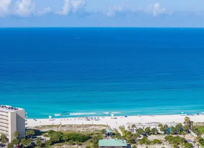 an aerial view of a beach and the ocean at PCB Luxe 4BR, Heated Pool, 3 Blks to Beach in Panama City Beach