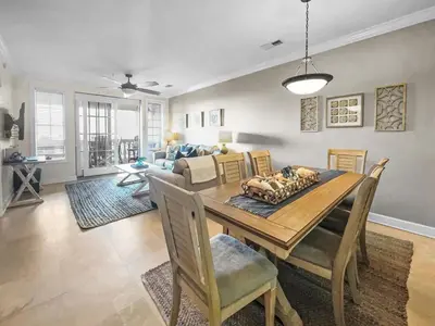 a dining room with a wooden table and chairs at The Flipside 30A l Heated Community Pool and Hot Tub l Steps to Rosemary Beach in Rosemary Beach