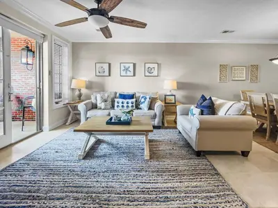 a living room with a couch and a table at The Flipside 30A l Heated Community Pool and Hot Tub l Steps to Rosemary Beach in Rosemary Beach