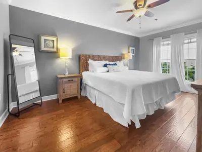a bedroom with a bed and a ceiling fan at The Flipside 30A l Heated Community Pool and Hot Tub l Steps to Rosemary Beach in Rosemary Beach
