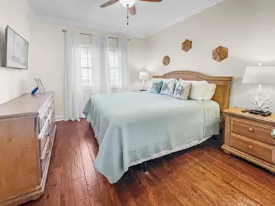 a bedroom with a large bed and a dresser at The Flipside 30A l Heated Community Pool and Hot Tub l Steps to Rosemary Beach in Rosemary Beach