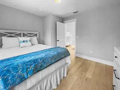 a bedroom with a bed with a blue blanket at The Way of Water l Community Pool l 2 Bikes included in Inlet Beach