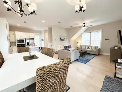 a dining room and living room with a table and chairs at The Way of Water l Community Pool l 2 Bikes included in Inlet Beach