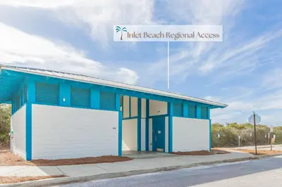 a blue and white building with a garage at The Way of Water l Community Pool l 2 Bikes included in Inlet Beach