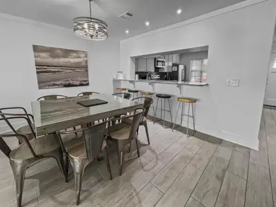 a kitchen and dining room with a table and chairs at Three Steps to the Beach l Beachfront l Steps To The Beach l Includes 2 Bikes in Inlet Beach